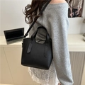 Fashionable black lychee grain leather bucket bag with top handle and shoulder strap - Black