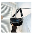 Detail of black glossy saddle bag featuring a bold silver chain and woven shoulder strap - Black