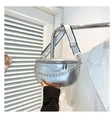 Detail of silver saddle bag featuring chunky metal chain and wide woven strap - Silver