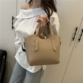Chic beige bucket bag with lychee texture held by model for a casual styling look - Khaki
