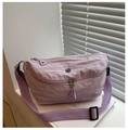 Detail of light purple nylon crossbody bag featuring double zippers and brand label - Purple