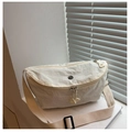 Detailed macro of a cream-colored crescent bag made from textured water-washed nylon fabric - White