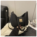 Detailed view of black matte saddle bag featuring a gold square buckle and adjustable strap - Black