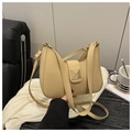 Detail of beige crescent bag featuring gold metal buckle and adjustable faux leather strap - Khaki