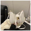 Detail of white leather crescent bag with adjustable strap and square gold buckle hardware - White