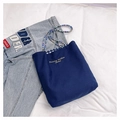 Detail of blue canvas tote bag with rainbow beaded straps and inner checkered lining - Blue