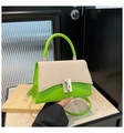 Detail view of contrast color handbag with fluorescent green finish and woven beige flap - Green