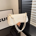 White minimalist leather shoulder bag with knot strap and gold XM & BAGS logo - White