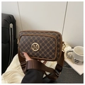 Close-up of vintage brown monogram bag with golden metal logo and wide fabric strap - Brown
