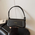 Elegant black leather hobo bag with a curved boat-shaped silhouette and gold hardware - Black