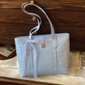 Light blue faux leather tote bag featuring puppy embossing and a white lace bow detail - With Silk Scarf / Blue
