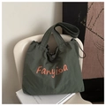Detail of dark green canvas tote with orange logo print and drawstring closure - Dark Green