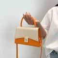 Contrast color orange and beige woven handbag with gold buckle and top handle strap - Orange