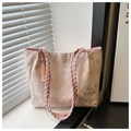 Close-up of pink lace tote bag with floral embroidery, butterfly patterns, and tassels - Pink