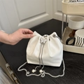 White crocodile embossed bucket bag with silver butterfly charm and pearl chain - White