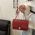 Red quilted chain crossbody bag in vibrant finish with silver metal clasp detail - Red