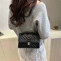 Chic black quilted chain crossbody bag with V-shaped stitching and metal clasp - Black
