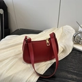 Red pebbled leather baguette bag with gold zipper and minimalist vintage design - Red