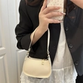 Mini cream pebble leather crescent handbag with gold hardware and top handle - White