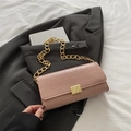Pink crocodile-embossed shoulder bag with gold chain strap on grey blazer - Pink
