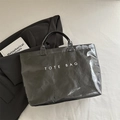 Glossy black tote bag with white TOTE BAG lettering and crinkled patent finish - Black