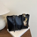 Large black matte leather tote bag with white contrast stitching and a patterned silk scarf - Black