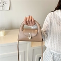 Khaki semi-circular handle trapezoid handbag with gold metal clasp and crossbody strap - Khaki