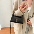 Minimalist black leather crossbody bag with golden buckle and slim strap detail - Black