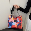 Waterproof nylon tote bag featuring vibrant geometric color blocks and chain handle - Black