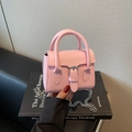 Pink PU leather mini handbag with silver buckle and chain strap shown in hand - Pink
