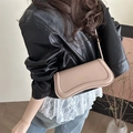 Elegant apricot minimalist underarm bag with unique curved design and gold lettering - Khaki