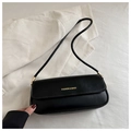 Detail of black leather baguette bag featuring golden Fashion & Bags logo and metal buckle - Black