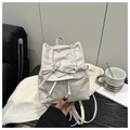 Detail of white PU leather mini backpack with bow accents and adjustable drawstring straps - White
