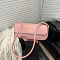 Minimalist pink leather shoulder bag with a rectangular flap design and gold lettering - Pink