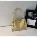 Close-up of cream yellow faux leather tote bag showing side knot detail and glossy texture - Yellow