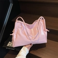 Minimalist light pink tote bag with glossy finish and decorative side knot detail - Pink