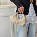 Chic off-white crescent handbag with metallic bow accent and wrinkled leather texture - Khaki
