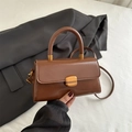 Brown vintage faux leather handbag with golden lock and top handle for women - Tan