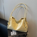Minimalist cream yellow tote bag featuring side pleats and knotted details in a sleek design - Yellow
