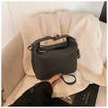 Detail of dark grey woven trapezoid handbag with gold buckle and textured finish - Black