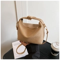 Detailed close-up of natural straw-woven small square bag with golden metal hardware - Khaki
