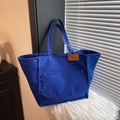 Royal blue canvas tote bag with contrast white stitching and brown leather trim accent - Blue