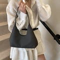 Chic black woven hobo bag with curved silhouette and minimalist braided texture finish - Black