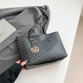 Black tote bag with M-letter monogram print and a round gold metal pendant - Black