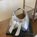 Metallic silver hobo bag with large bow and chain strap in a stylish setup - Silver