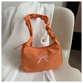 Detail of orange fabric baguette bag with white bow embroidery and scrunchie handle - Orange