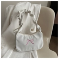 Close-up of white fabric underarm bag featuring pink embroidered bow and ruffled handle - White