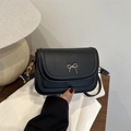 Mini black leather crossbody bag with vintage golden bow clasp and layered flap design - Black