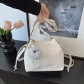 Chic white PU leather bucket bag with plush monster charm and golden hardware detail - With White Eye Pendant / Off White
