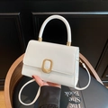 Elegant white square handbag with a gold buckle and detachable shoulder strap in a stylish pose - White